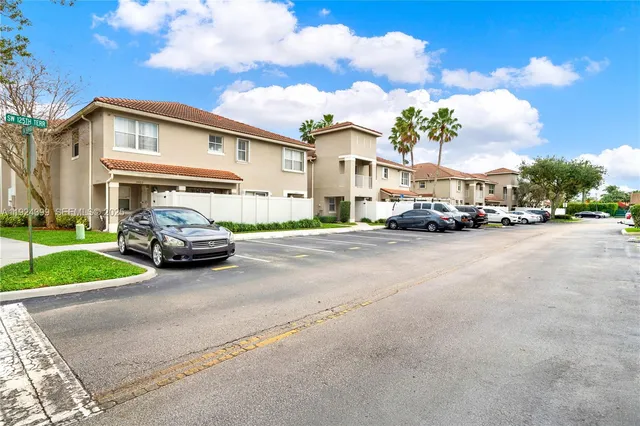 a view of road with card parked cars and parked cars