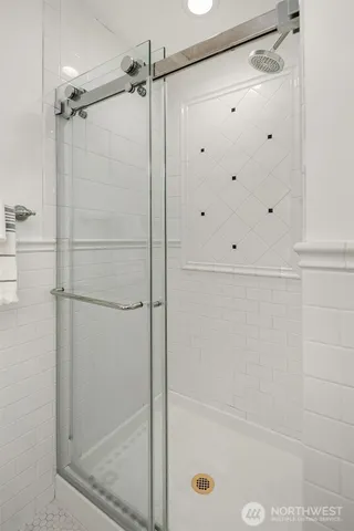a bathroom with a glass shower door