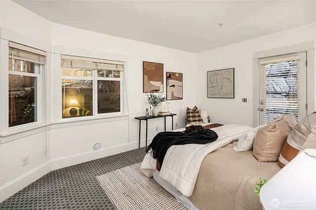 a bedroom with a bed and glass windows