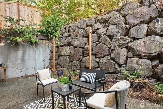 a view of a chairs and table in backyard