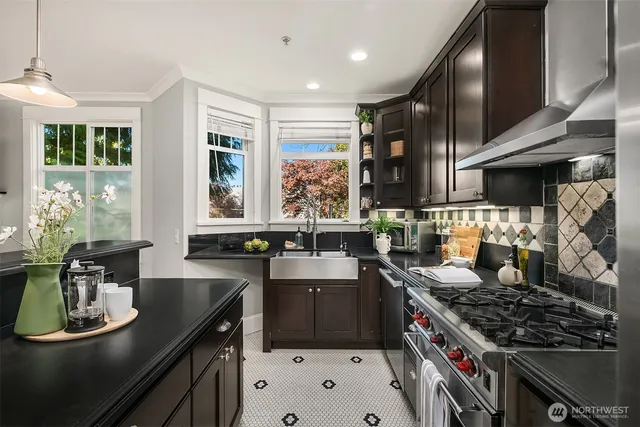 a kitchen with stove a sink and cabinets
