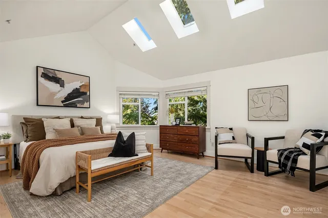 a bedroom with a bed a bookshelf a desk and chair with window