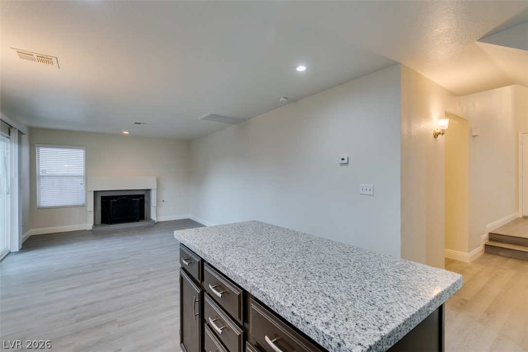 1738 Toltec Circle Henderson, NV 89014 - Photo 23 of 46 A well-lit living area with a fireplace offers a welcoming atmosphere.