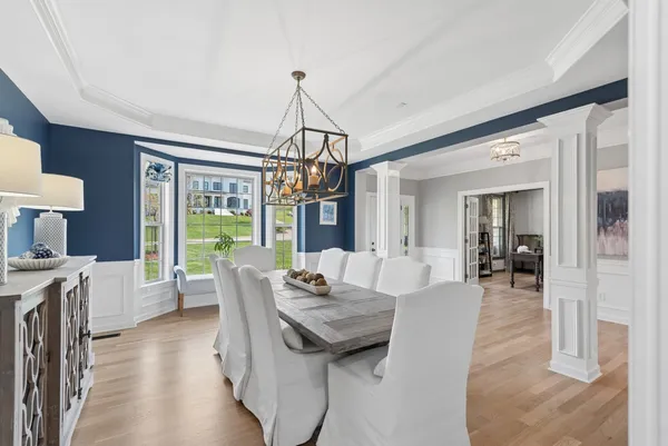 a kitchen with stainless steel appliances kitchen island granite countertop a sink a stove a dining table and chairs