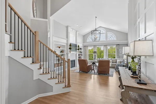 a kitchen with stainless steel appliances granite countertop a stove a sink dishwasher and a microwave oven with white cabinets