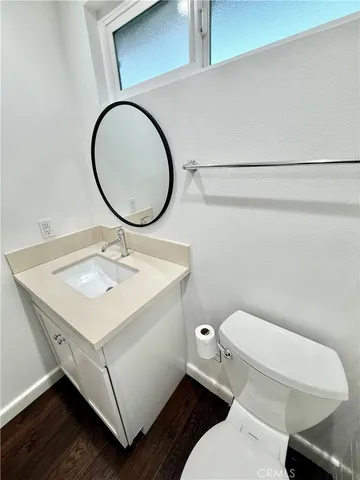 a bathroom with a toilet a sink and a mirror
