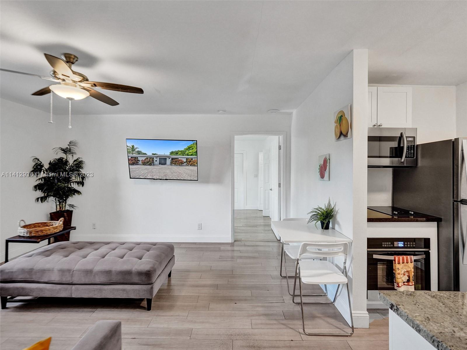 2500 Northeast 19th Street Pompano Beach, FL 33062 - Photo 13 of 51 a living room with furniture and a flat screen tv