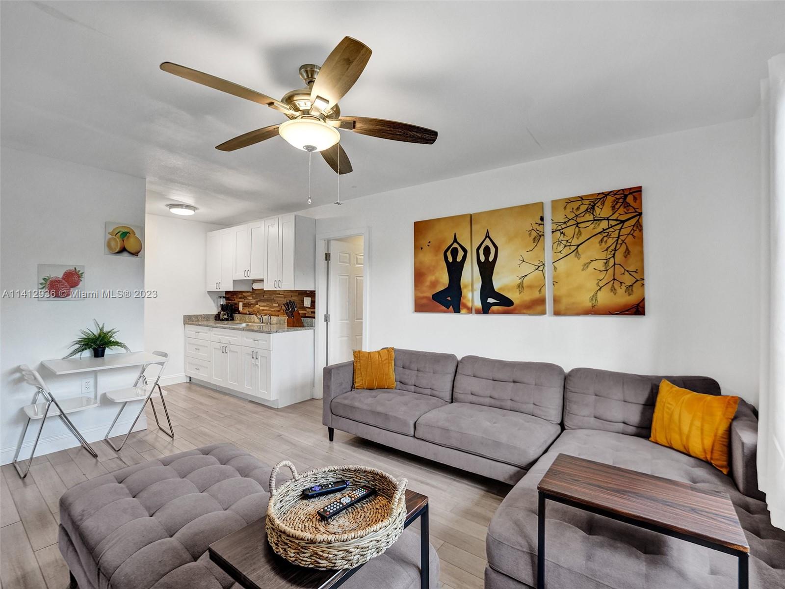2500 Northeast 19th Street Pompano Beach, FL 33062 - Photo 15 of 51 a living room with furniture kitchen view and a chandelier