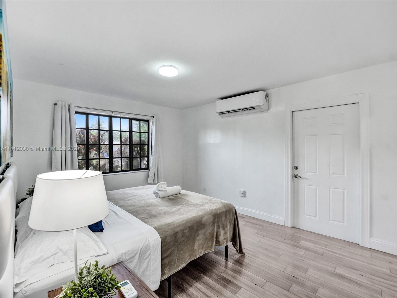 2500 Northeast 19th Street Pompano Beach, FL 33062 - Photo 18 of 51 a bedroom with a bed and a window