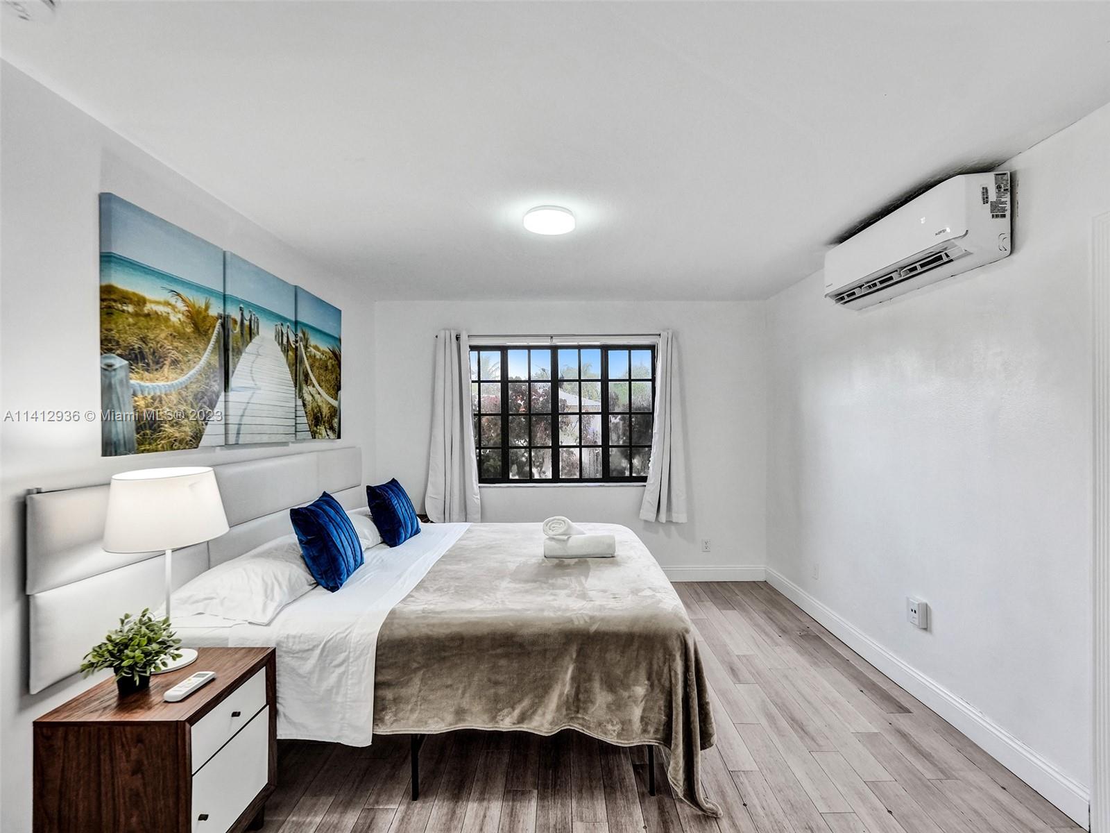 2500 Northeast 19th Street Pompano Beach, FL 33062 - Photo 19 of 51 a bedroom with a bed and a large window