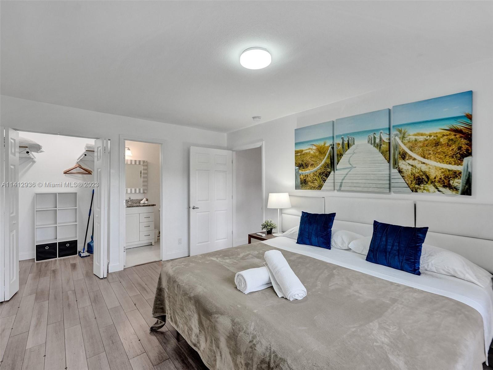 2500 Northeast 19th Street Pompano Beach, FL 33062 - Photo 20 of 51 a bedroom with a bed and a couch