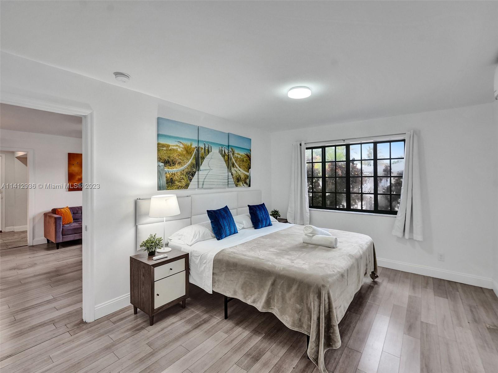 2500 Northeast 19th Street Pompano Beach, FL 33062 - Photo 21 of 51 a bedroom with a bed and a large window