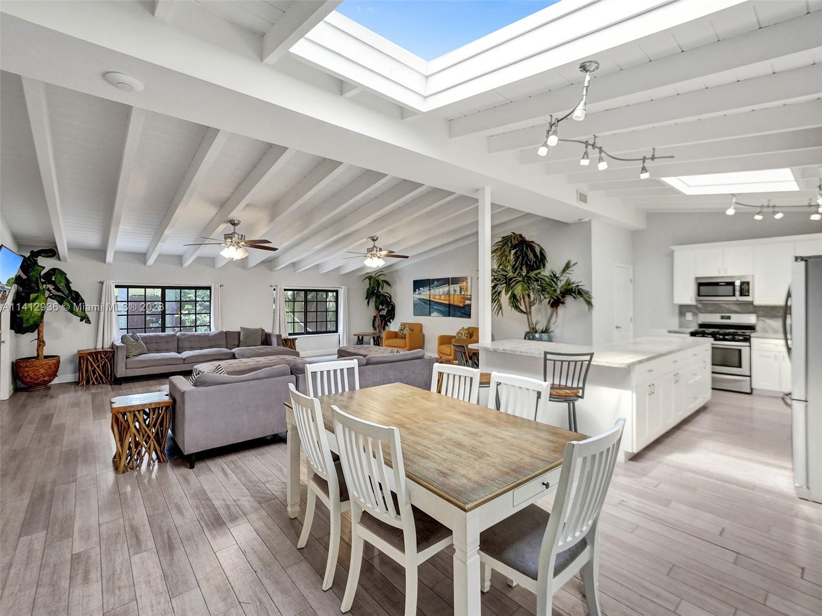 2500 Northeast 19th Street Pompano Beach, FL 33062 - Photo 3 of 51 a view of a dining room with furniture window and wooden floor