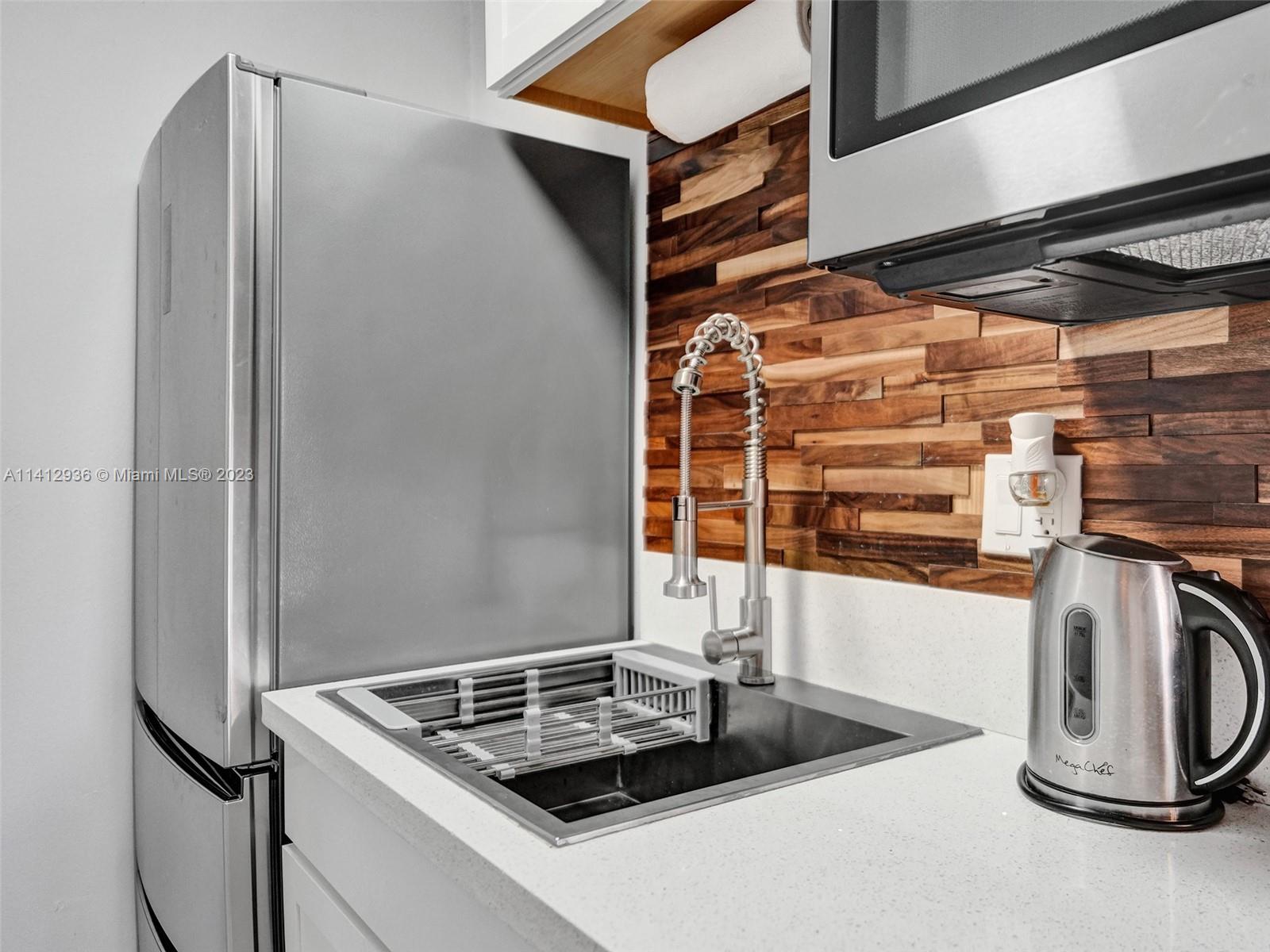 2500 Northeast 19th Street Pompano Beach, FL 33062 - Photo 33 of 51 a kitchen with a refrigerator and a stove