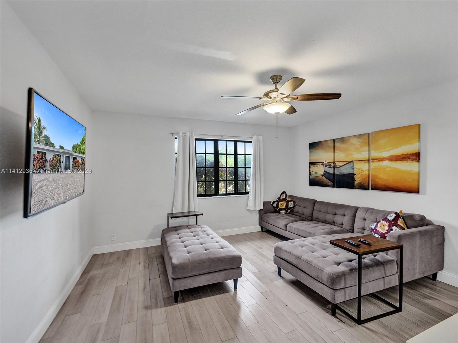2500 Northeast 19th Street Pompano Beach, FL 33062 - Photo 34 of 51 a living room with furniture ceiling fan and a flat screen tv