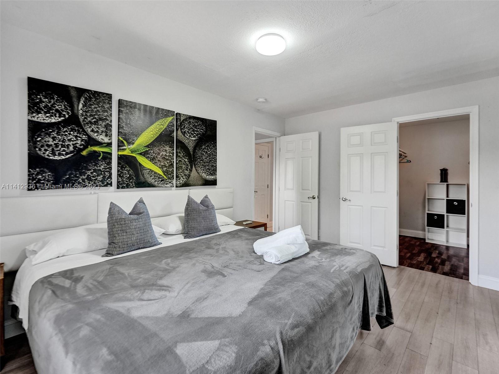 2500 Northeast 19th Street Pompano Beach, FL 33062 - Photo 39 of 51 a bedroom with a bed and a view of kitchen