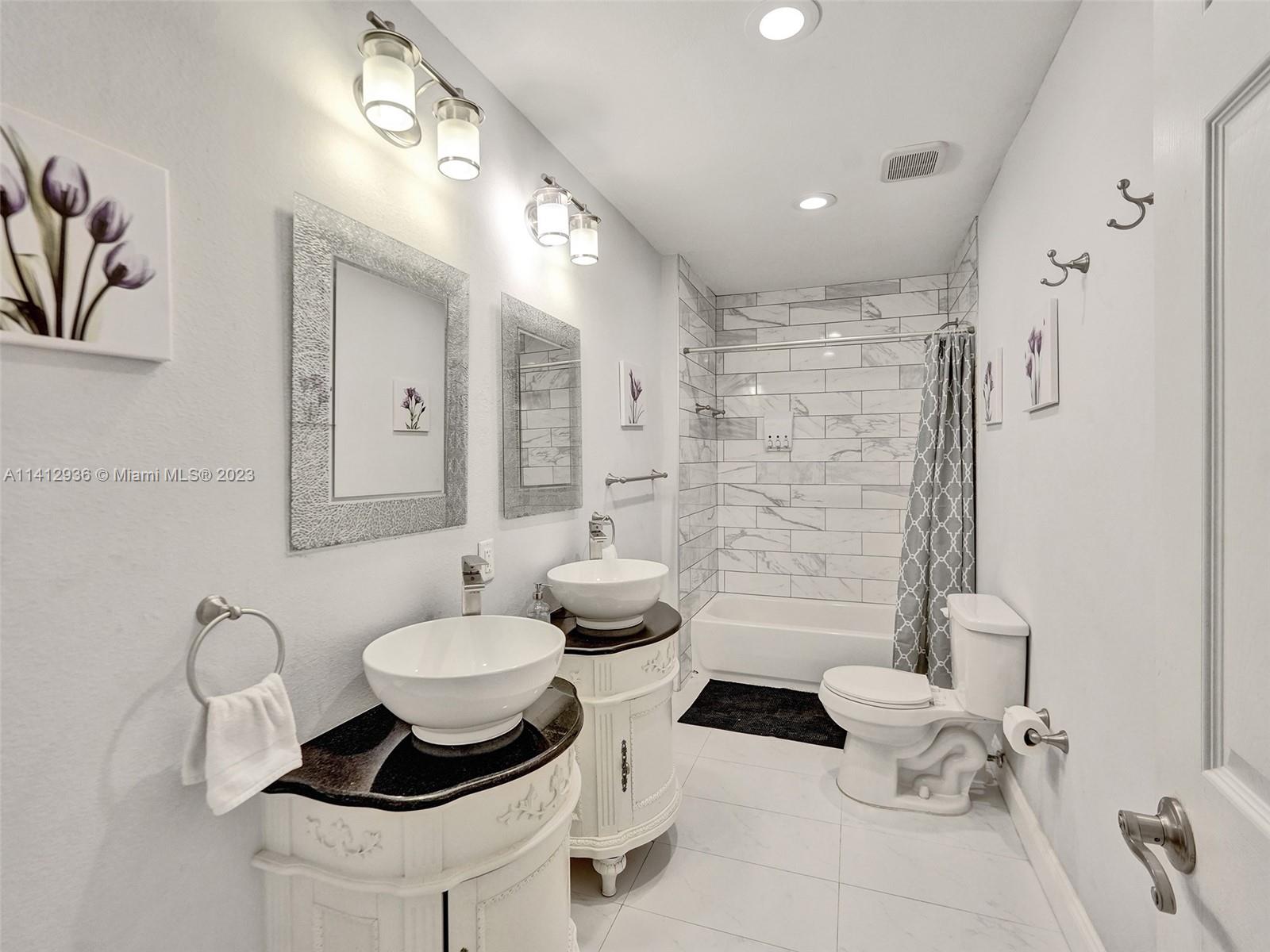 2500 Northeast 19th Street Pompano Beach, FL 33062 - Photo 41 of 51 a bathroom with a sink toilet and shower