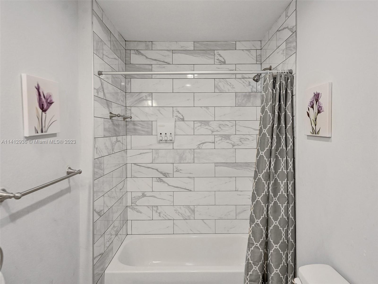 2500 Northeast 19th Street Pompano Beach, FL 33062 - Photo 42 of 51 a bathroom with a shower curtain