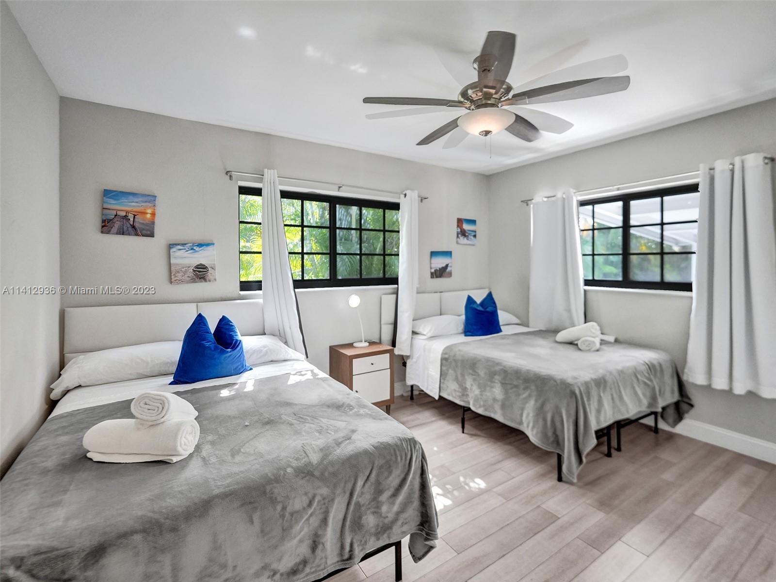 2500 Northeast 19th Street Pompano Beach, FL 33062 - Photo 43 of 51 a bedroom with two beds and windows