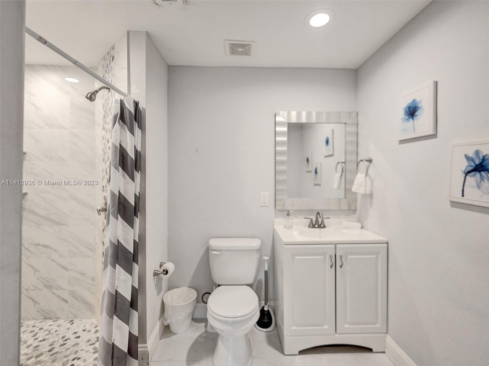 2500 Northeast 19th Street Pompano Beach, FL 33062 - Photo 46 of 51 a bathroom with a sink toilet and shower