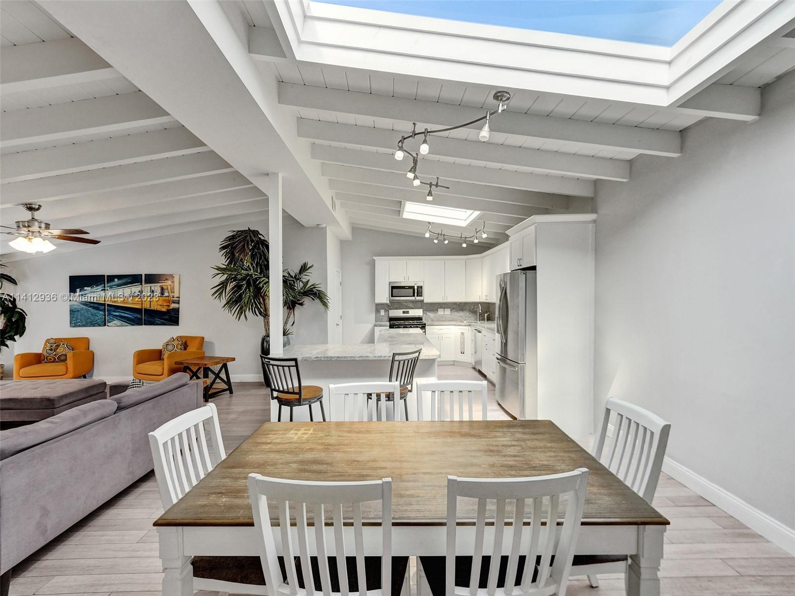 2500 Northeast 19th Street Pompano Beach, FL 33062 - Photo 5 of 51 a dining room with a wooden table and chairs