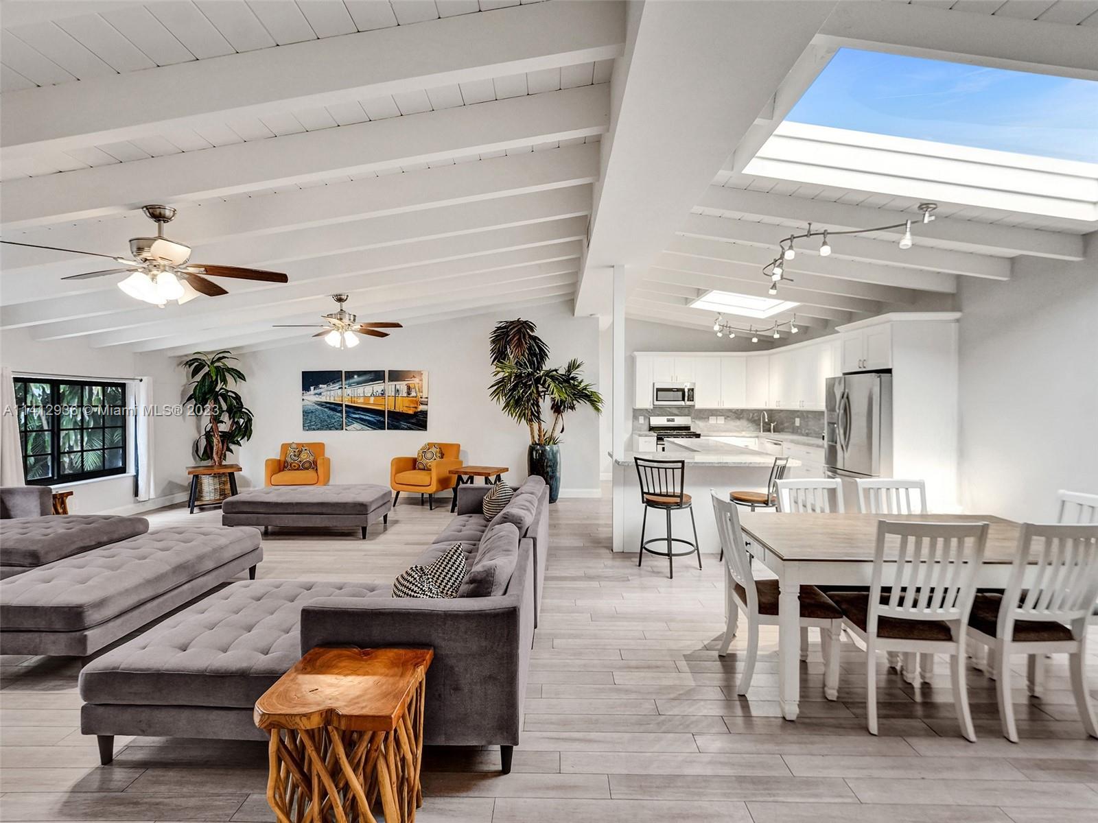 2500 Northeast 19th Street Pompano Beach, FL 33062 - Photo 6 of 51 a living room with furniture kitchen view and a table