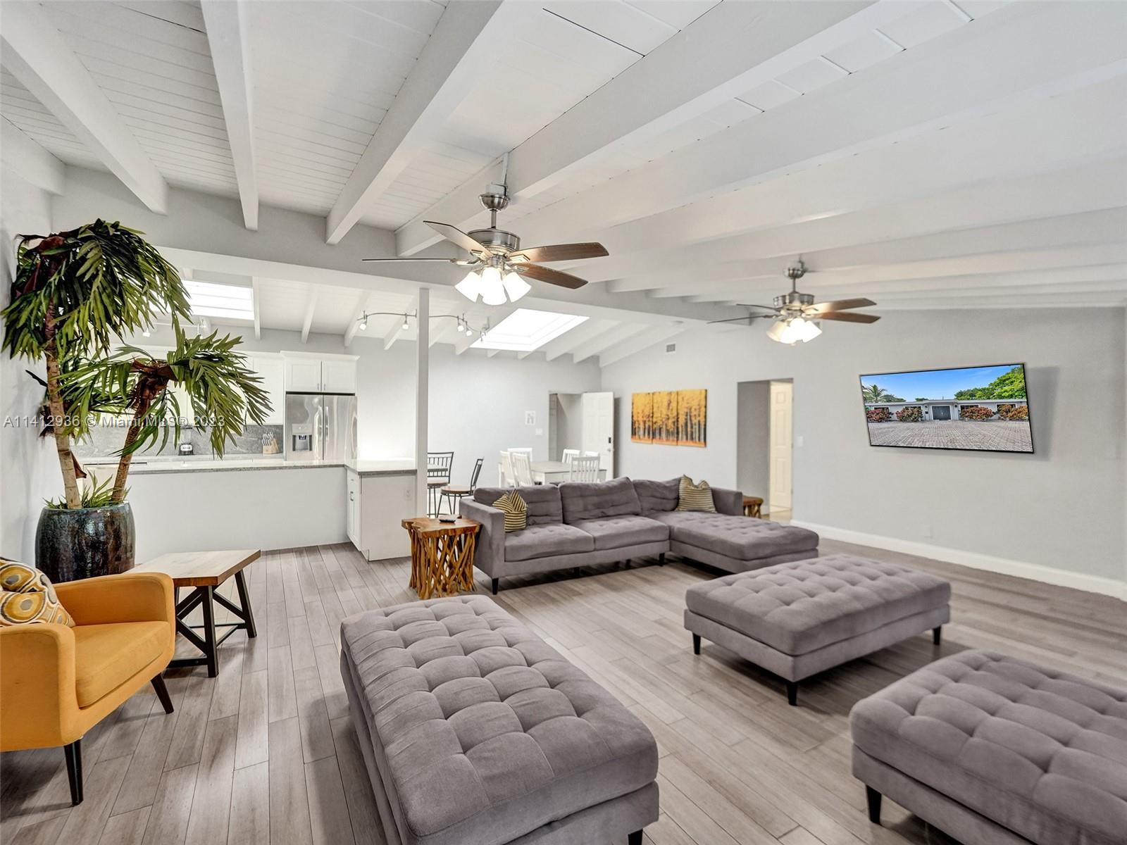2500 Northeast 19th Street Pompano Beach, FL 33062 - Photo 9 of 51 a living room with furniture and a chandelier