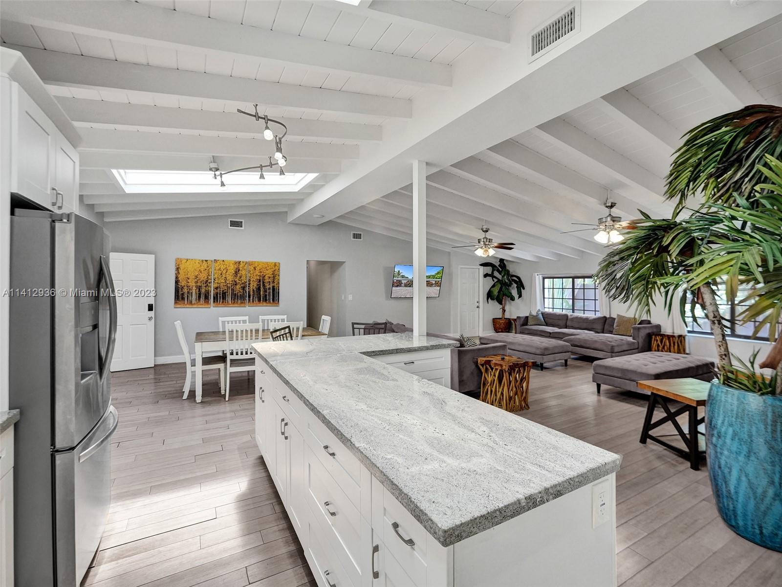 2500 Northeast 19th Street Pompano Beach, FL 33062 - Photo 10 of 51 a kitchen with stainless steel appliances granite countertop sink stove and refrigerator