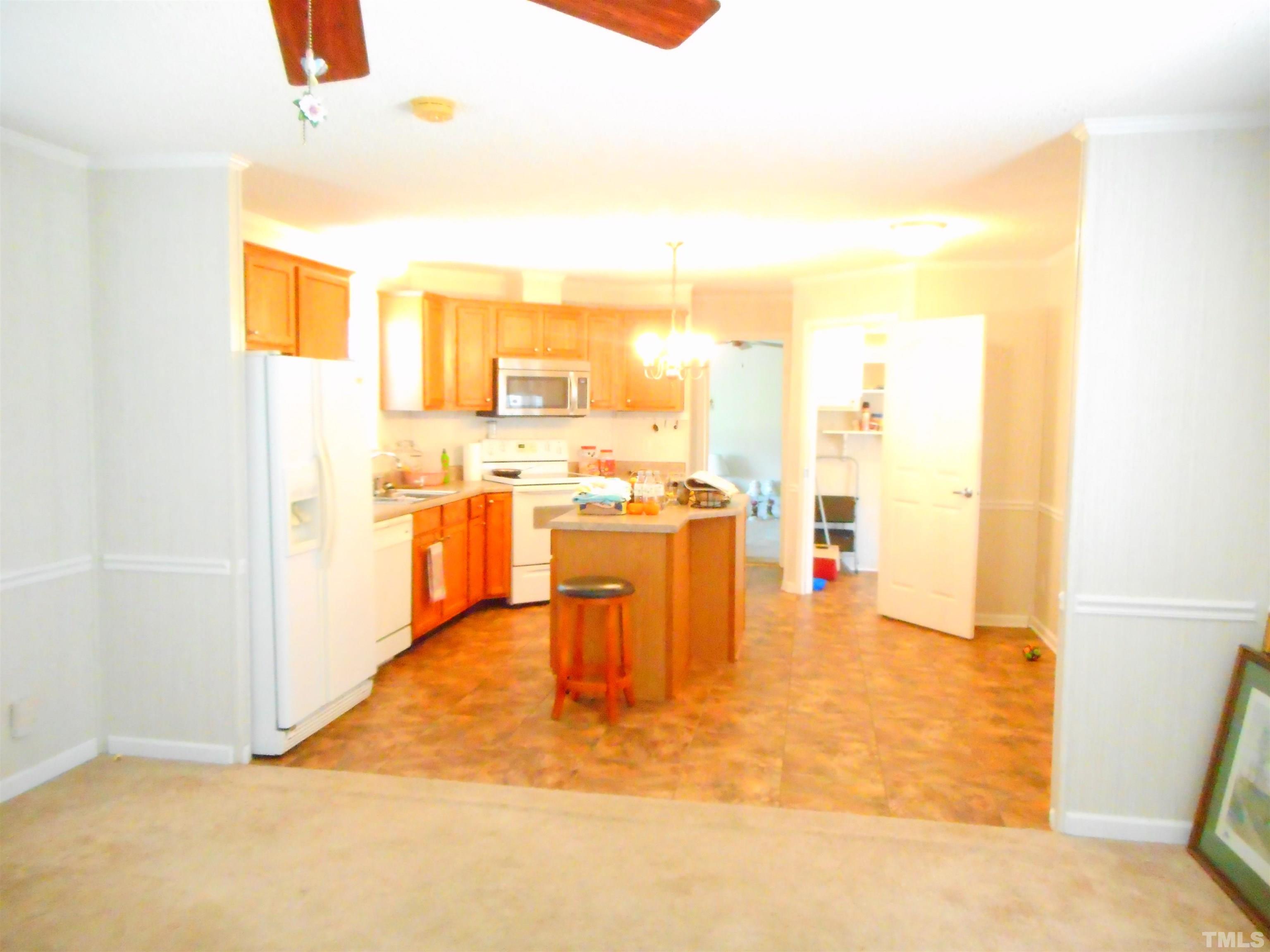 8605 Ransom Lane Kenly, NC 27542 - Photo 13 of 38 a view of a living room with furniture and a kitchen
