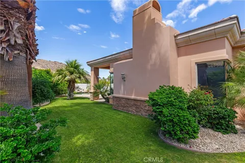 a view of a house with a yard and plants