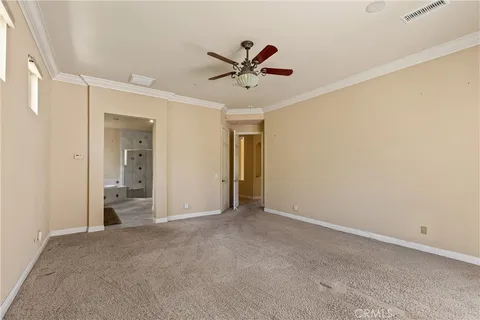 a view of an empty room with a ceiling fan