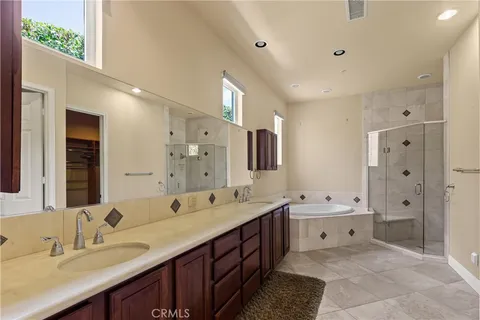 a spacious bathroom with a double vanity sink mirror double and shower