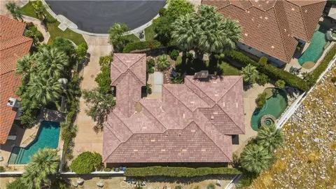 a view of a house with a yard and potted plants