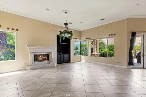 a view of an empty room with a fireplace and a window