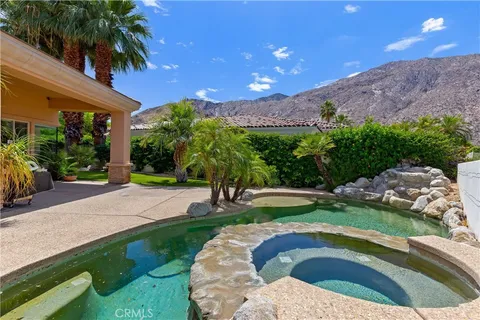 a swimming pool with outdoor seating and yard