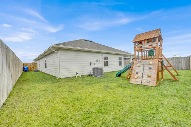 an aerial view of a house with a garden and swimming pool