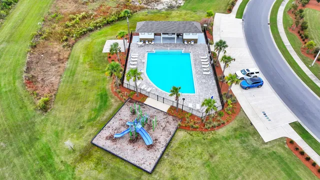 an aerial view of a house with a yard and a garden