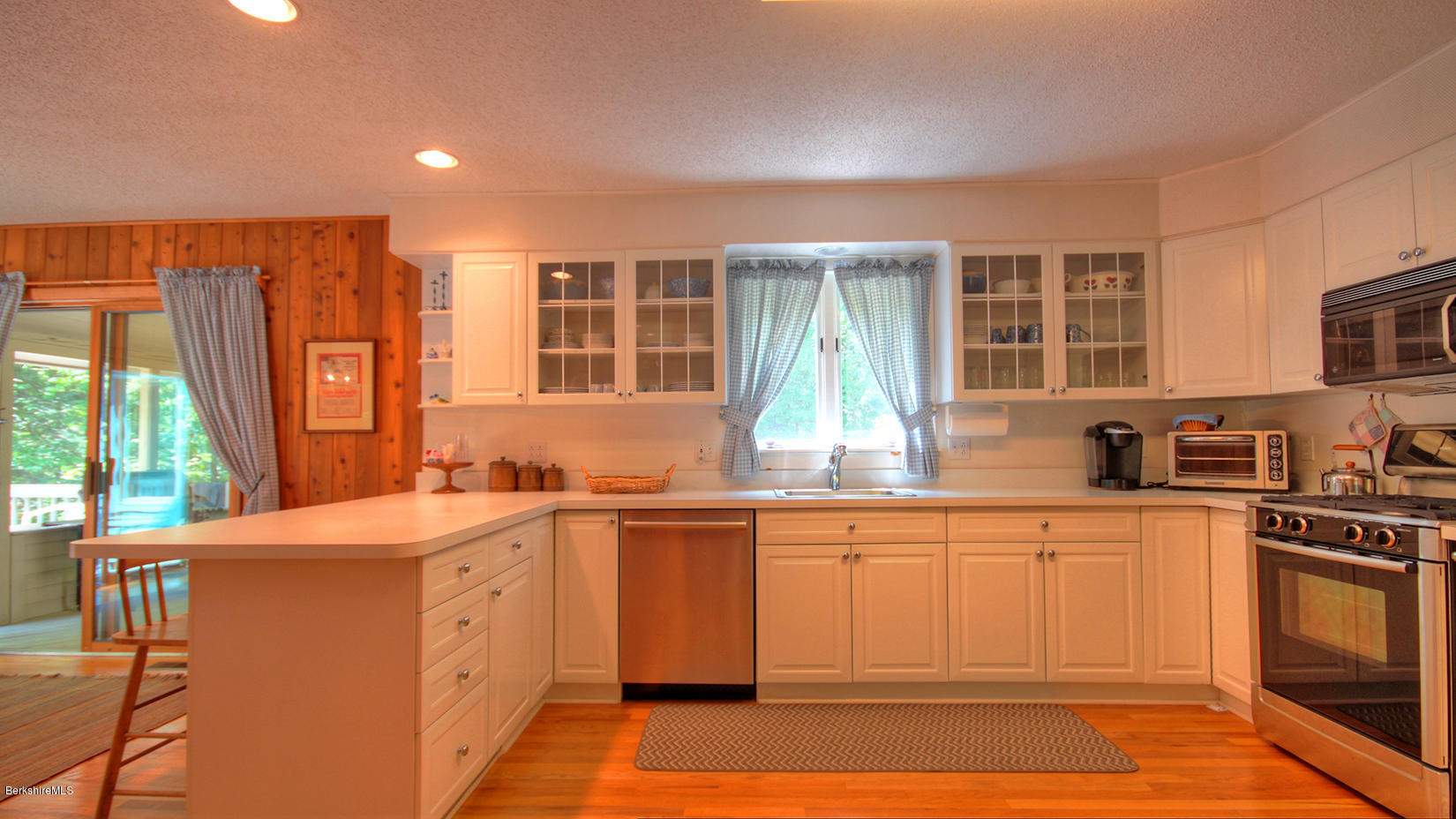 33 Sioux Road Becket, MA 01223 - Photo 12 of 33 a kitchen with stainless steel appliances granite countertop a sink stove and cabinets