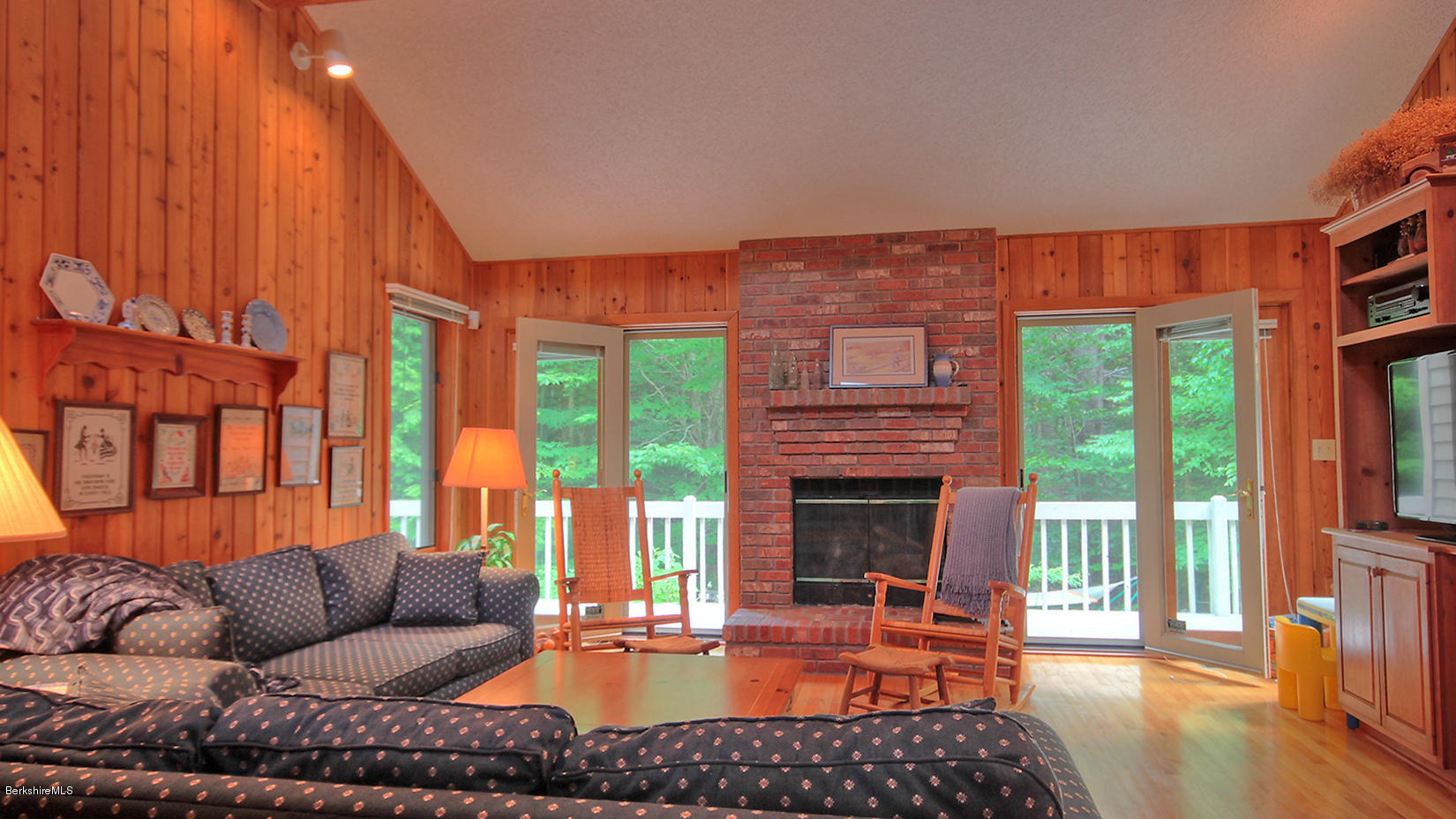 33 Sioux Road Becket, MA 01223 - Photo 7 of 33 a living room with furniture a fireplace and a floor to ceiling window