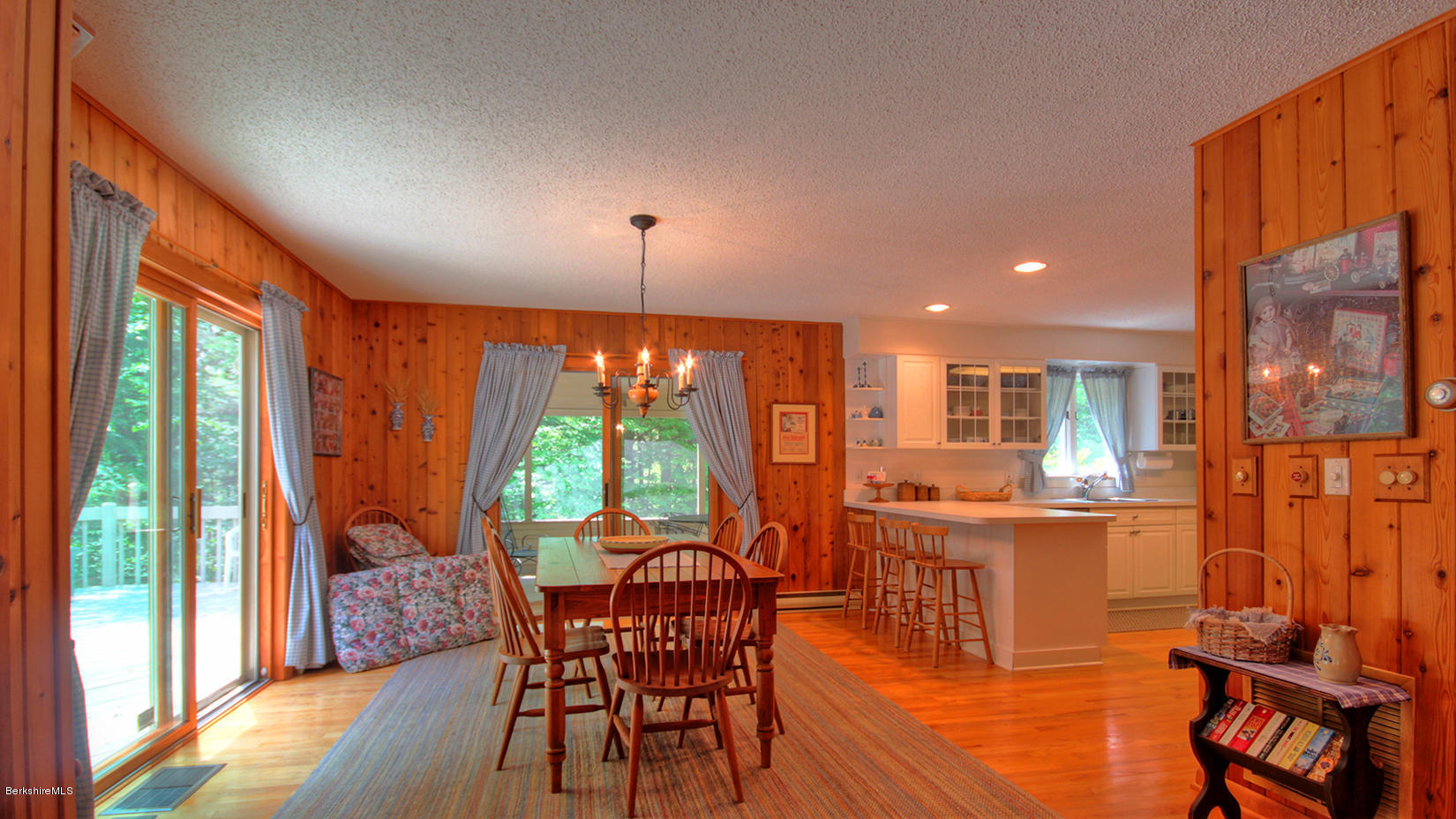 33 Sioux Road Becket, MA 01223 - Photo 10 of 33 a dining room with furniture large windows and wooden floor