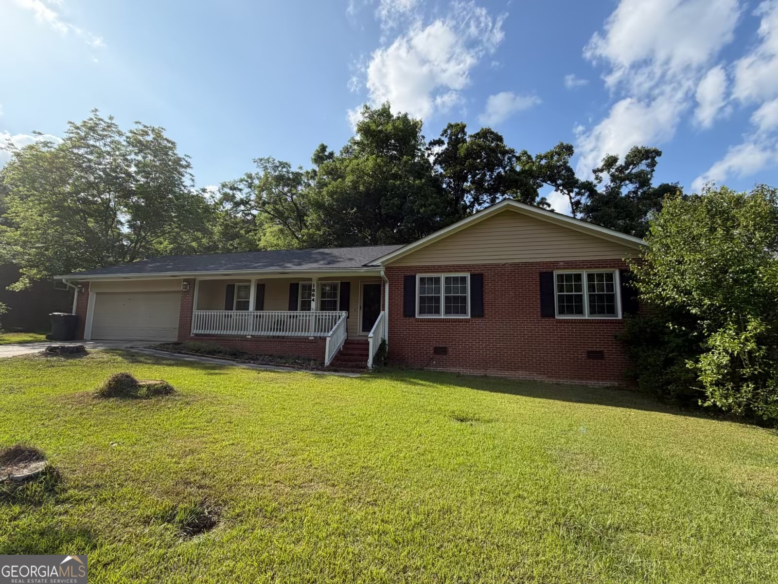 1864 Timberlane Road Milledgeville, GA 31061 - Photo 1 of 2 a front view of a house with a garden and trees