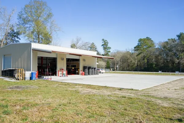 a view of a house with a yard and sitting area