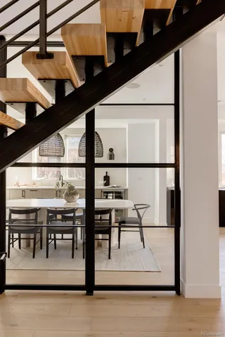 a view of a hallway with wooden floor and furniture