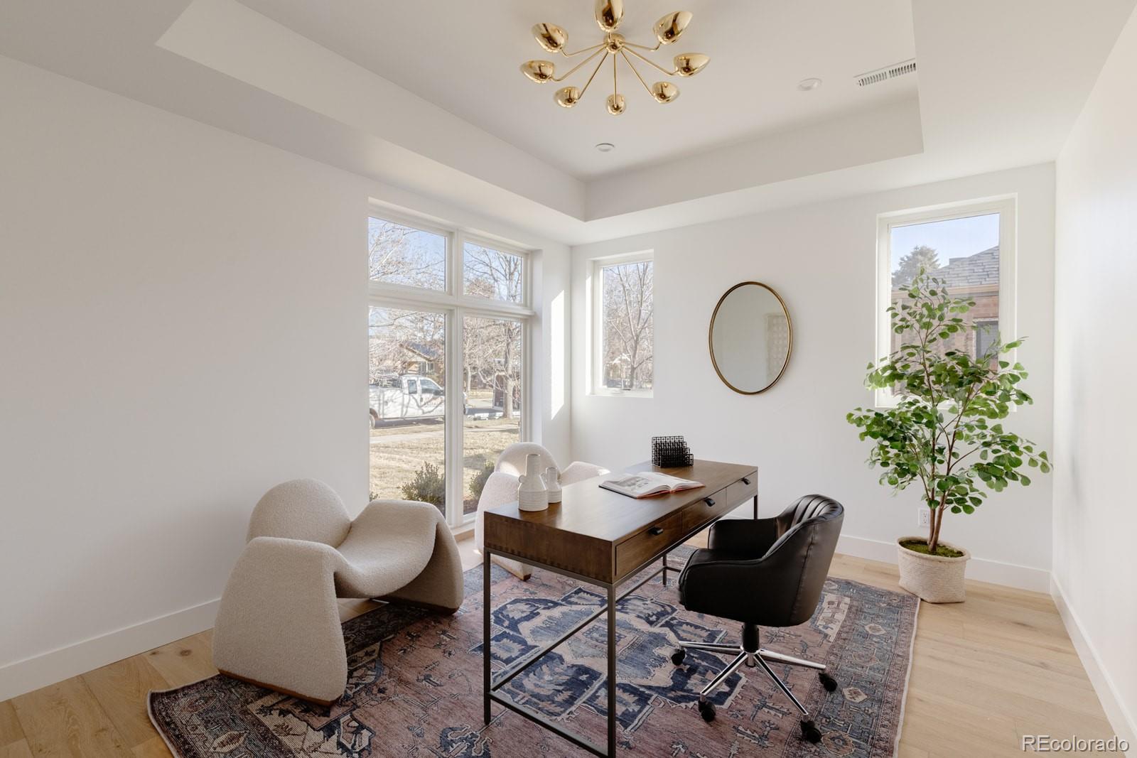 2112 Perry Street Denver, CO 80212 - Photo 14 of 49 a living room with furniture a chandelier and a window