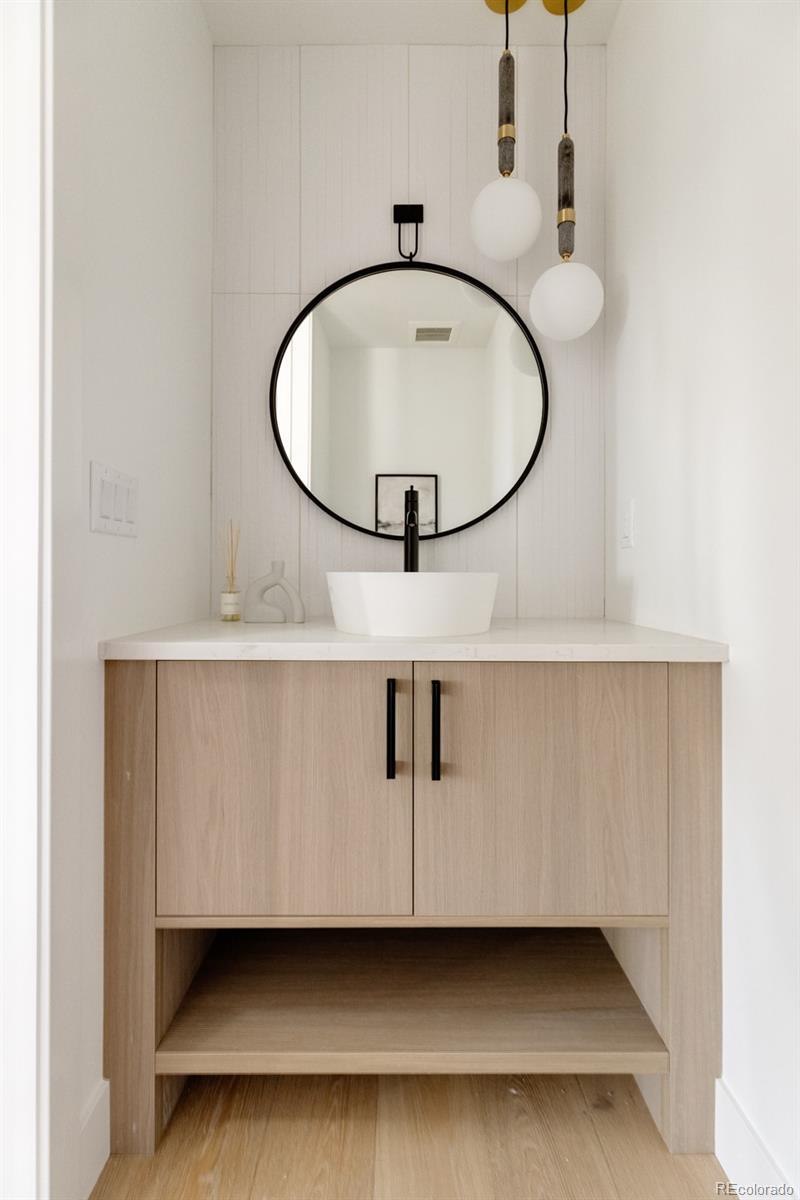 2112 Perry Street Denver, CO 80212 - Photo 15 of 49 a bathroom with a sink a mirror and a lamp