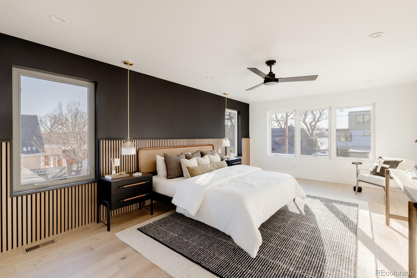 2112 Perry Street Denver, CO 80212 - Photo 17 of 49 a bedroom with a large bed and a chandelier