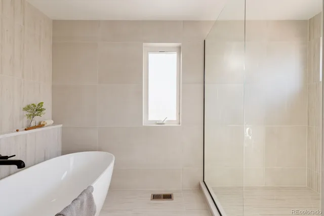 a bathroom with a tub shower and a sink