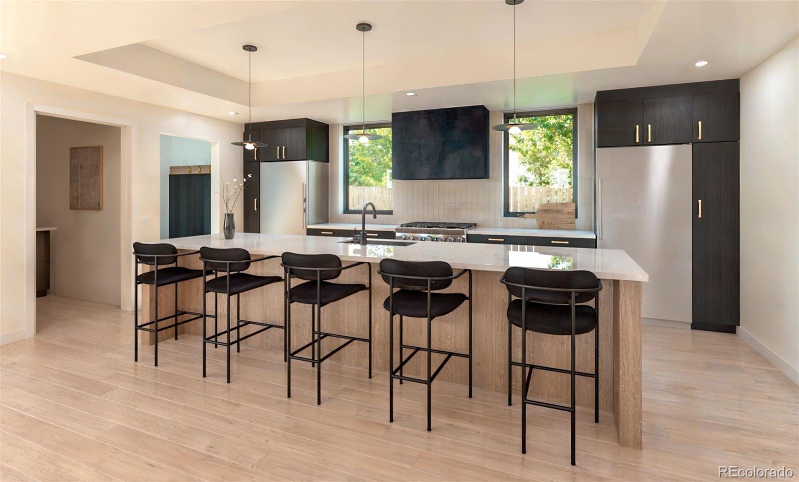 2112 Perry Street Denver, CO 80212 - Photo 2 of 49 a kitchen with a dining table chairs sink and cabinets