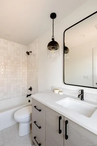 a bathroom with a sink a mirror and a bathtub