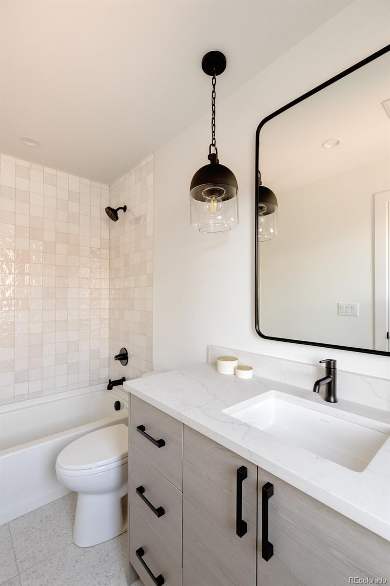 2112 Perry Street Denver, CO 80212 - Photo 22 of 49 a bathroom with a sink a toilet and shower